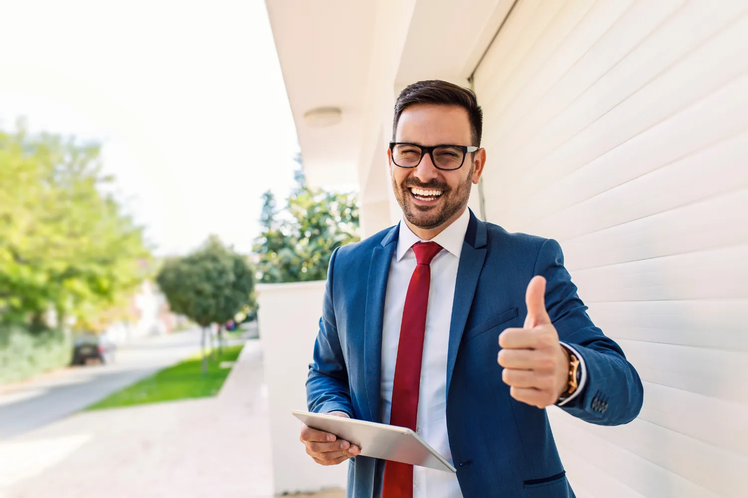 Person in suit showing thumbs up